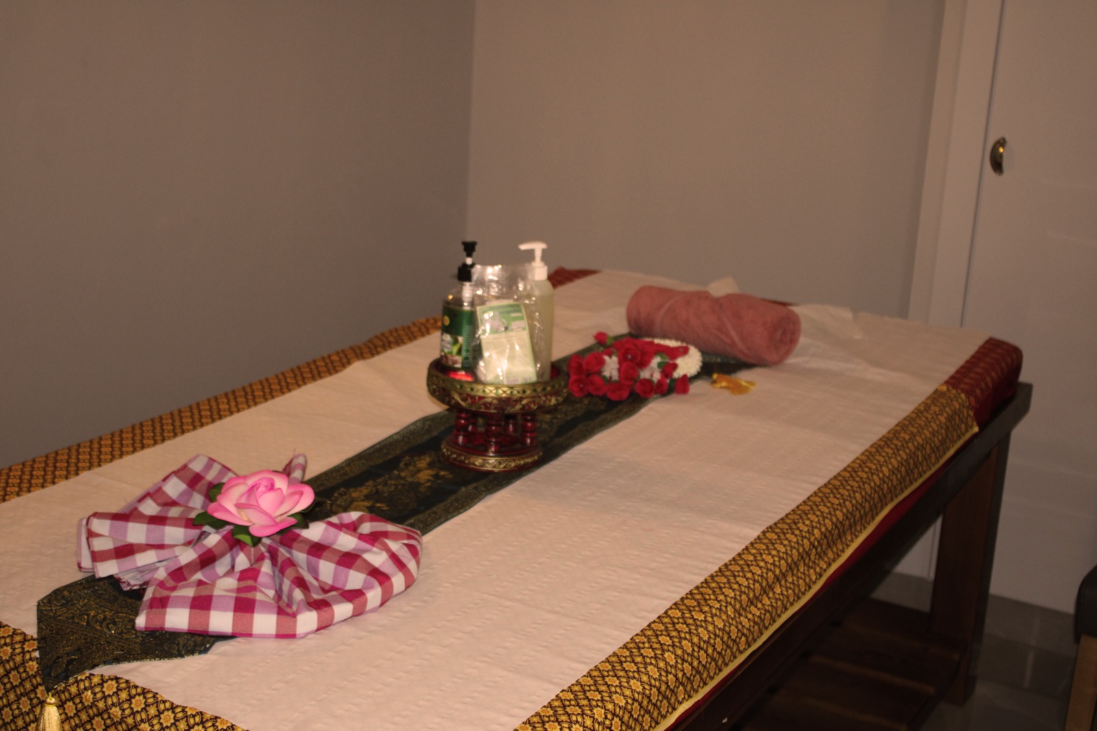 Authentic Thai massage table set with oils, rose and herbal compress