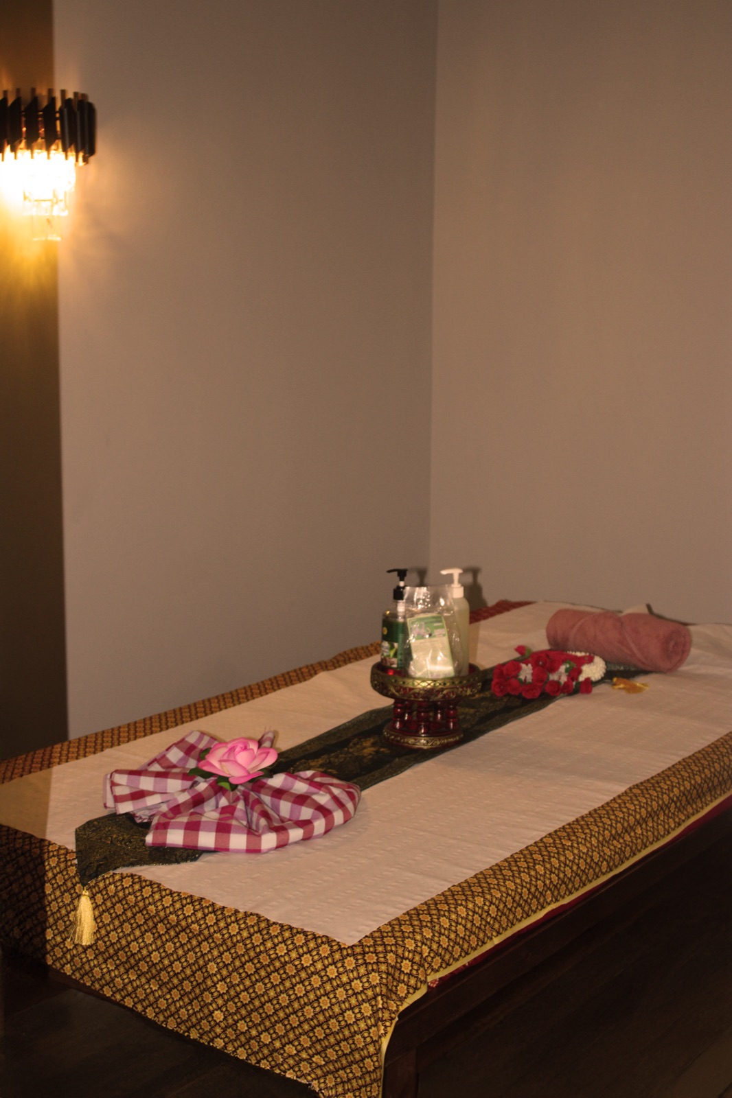 Warm Thai treatment room at Jazmine, dressed with silk and fresh linens