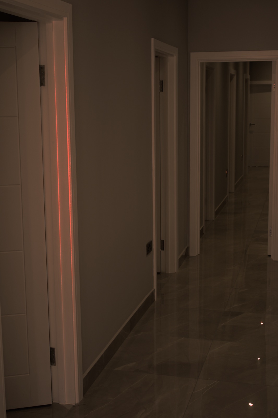 Private, softly-lit corridor of treatment rooms